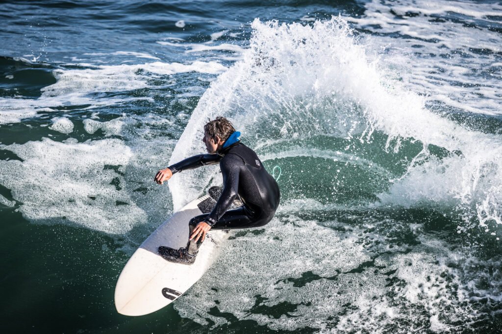 Surfer riding a wave at Steamer Lane Santa Cruz USA with ocean spray
