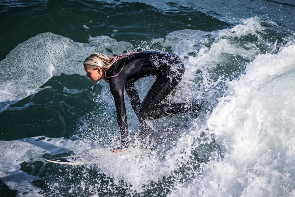 Female surfer rides a wave at Steamer Lane, Santa Cruz, California, USA