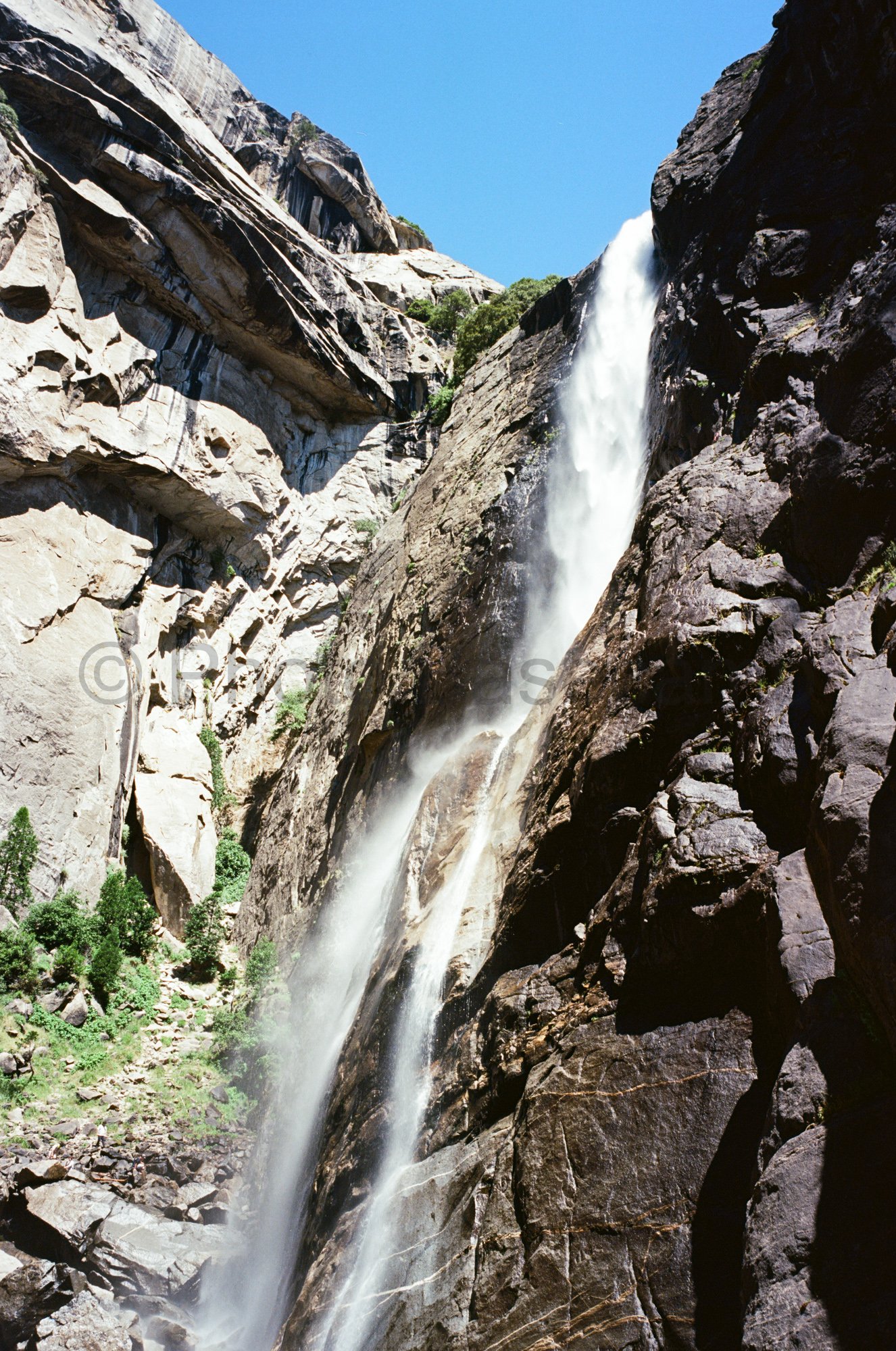 Majestic waterfall cascading down granite cliff face in Yosemite National Park, California, USA Majestic waterfall cascading down granite cliff face in Yosemite National Park, California, USA