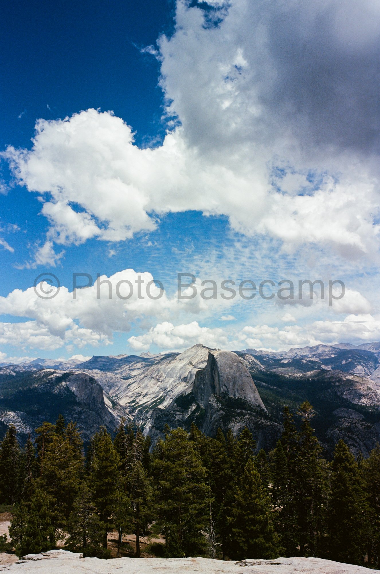 Classic Yosemite landscape with Half Dome, pine trees and a cloudy sky Classic Yosemite landscape with Half Dome, pine trees and a cloudy sky