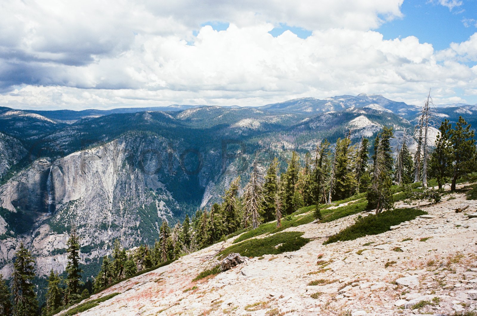 High angle panoramic view of Yosemite Falls cascading into Yosemite Valley in Yosemite National Park. High angle panoramic view of Yosemite Falls cascading into Yosemite Valley in Yosemite National Park.